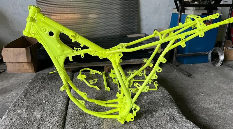 Motorcycle frame powder coated in fluorescent yellow Mid Cornwall Powder Coating Bodmin