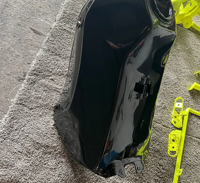 Motorcycle fuel tank finished in gloss black powder coat Mid Cornwall Powder Coating